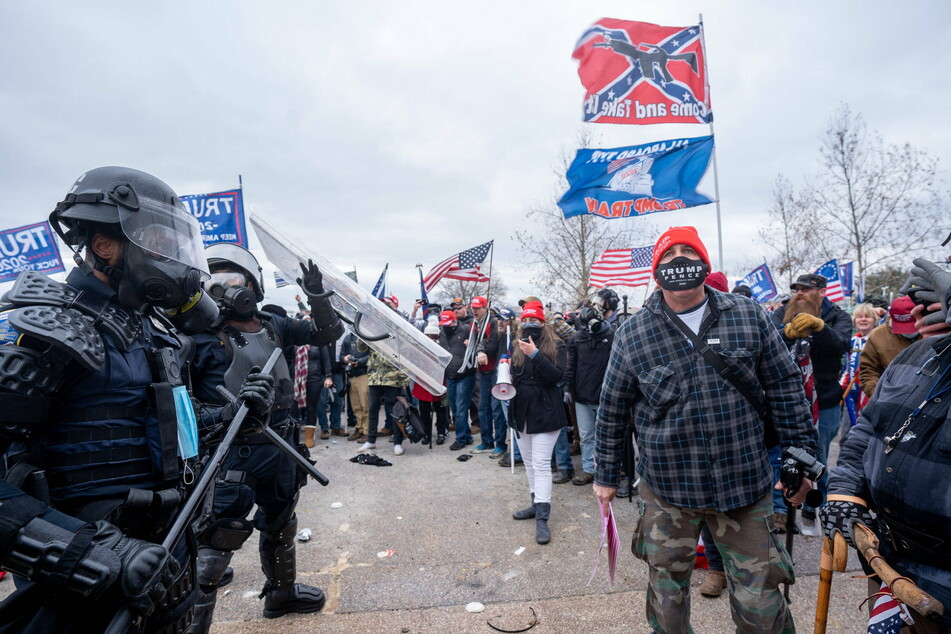 Rioters wave Confederate flags as they storm the Capitol on January 6, 2021.
