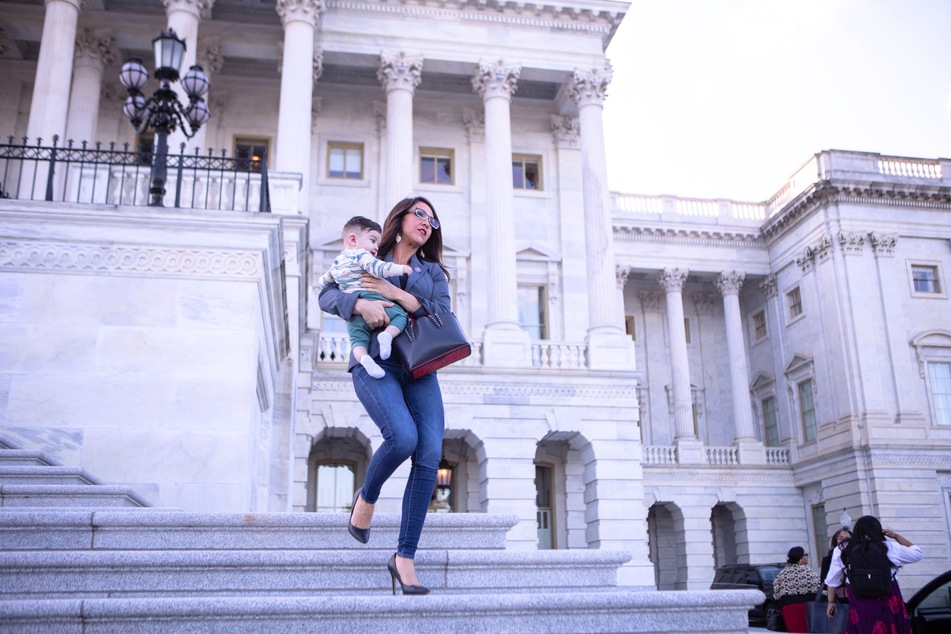 Lauren Boebert carrying her grandson, the infant child of her son Tyler, in front of the Capitol building in Washington DC last year.