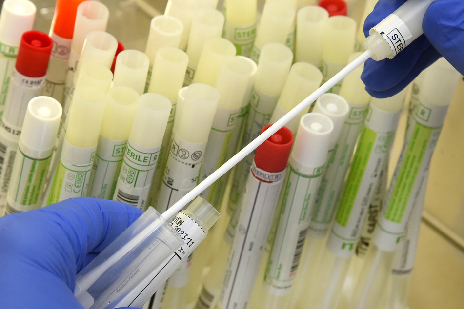 Sachsen, Leipzig: In einem PCR-Labor vom MVZ Labor bereitet die Leiterin der infektiologischen PCR-Abteilung an der Sicherheitswerkbank Abstrichtupfer von Patienten für die SARS-CoV-2-Diagnostik an einem Analysegerät vor.