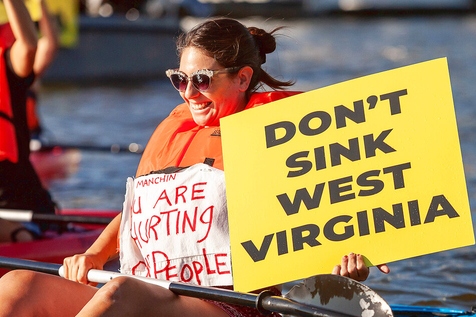 West Virginians protest at Senator Joe Manchin s houseboat, Almost Heaven, to pressure the senator to pass the proposed Build Back Better legislature.