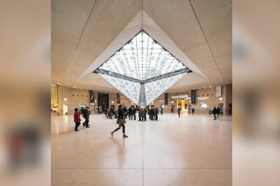 Die auf dem Kopf stehende Pyramide spiegelt in der Mall die Pyramide des Louvre.