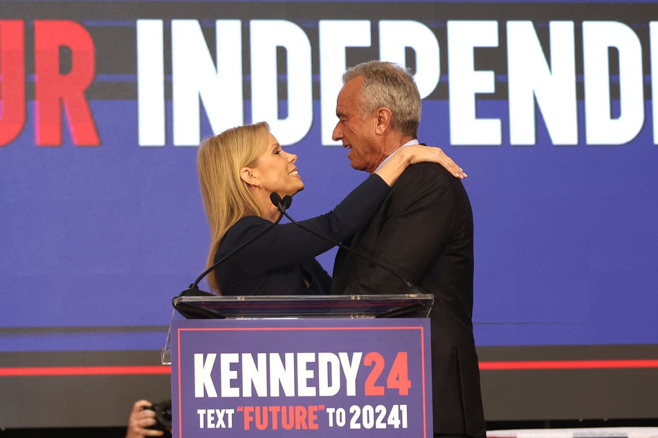 Cheryl Hines embraces her husband, presidential candidate Robert F. Kennedy Jr., during a campaign event in Oakland, California on March 26, 2024.