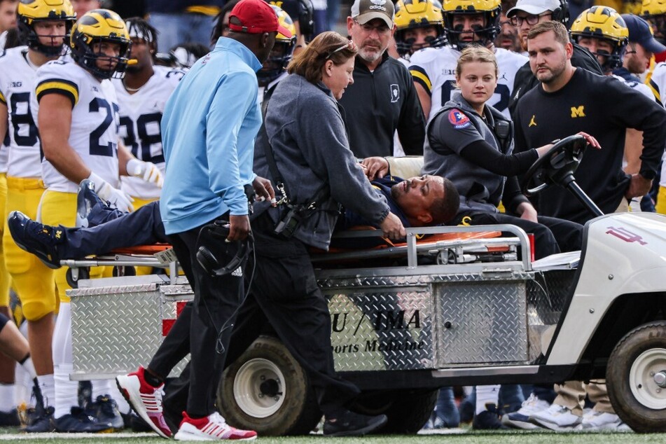 Michigan Wolverines running back coach Mike Hart was carted off of the field during the first half of Saturday's game against the Indiana Hoosiers at Memorial Stadium.