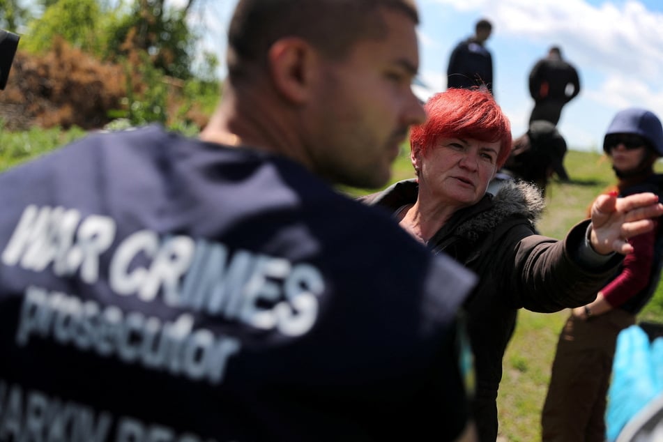 War crimes prosecutors on the scene outside of Kharkiv, Ukraine.