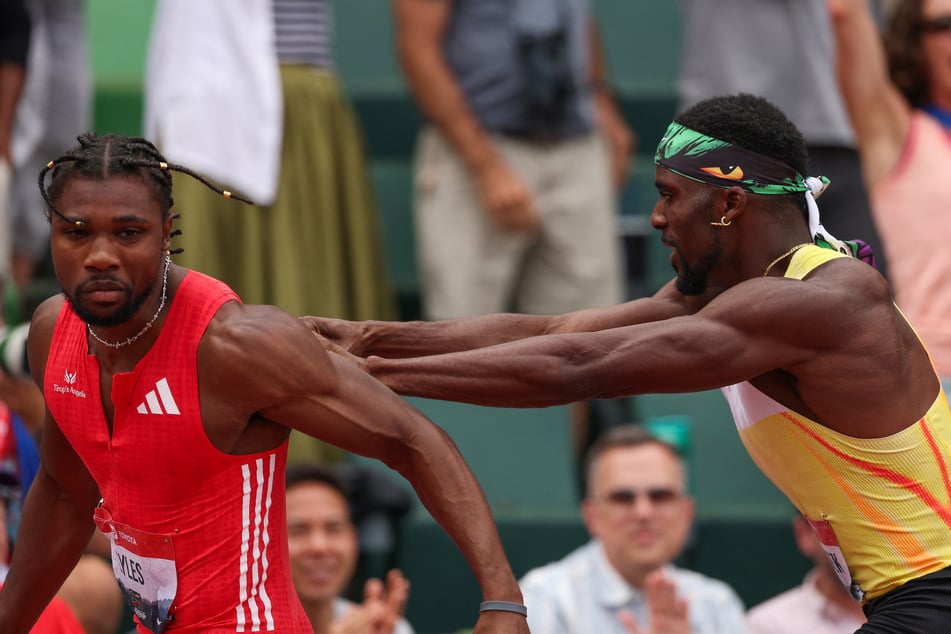Noah Lyles is pushed by Kenny Bednarek following the Xfinity Men's 200m final during the 2025 USATF Outdoor Championships.