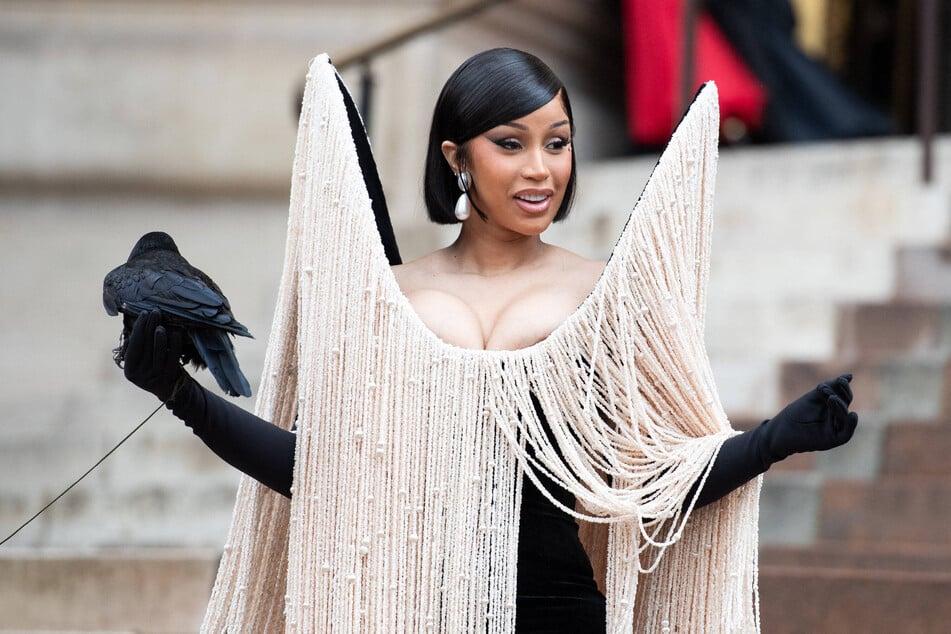 Cardi B posed with a live black bird while attending the Schiaparelli Haute Couture Fall/Winter 2025/2026 show.