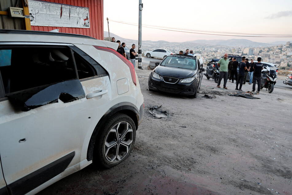 People assess the scene where an Israeli drone strike killed Palestinians, in Tubas in the occupied West Bank, on September 5, 2024.