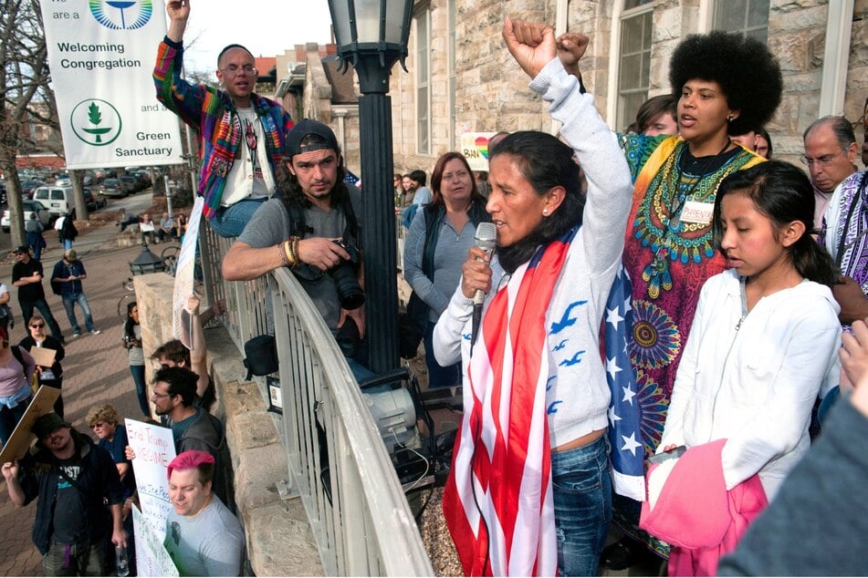 Jeanette Vizguerra holds her fist up high as she addresses supporters gathered outside the First Unitarian Church in Denver, Colorado on February 18, 2017.