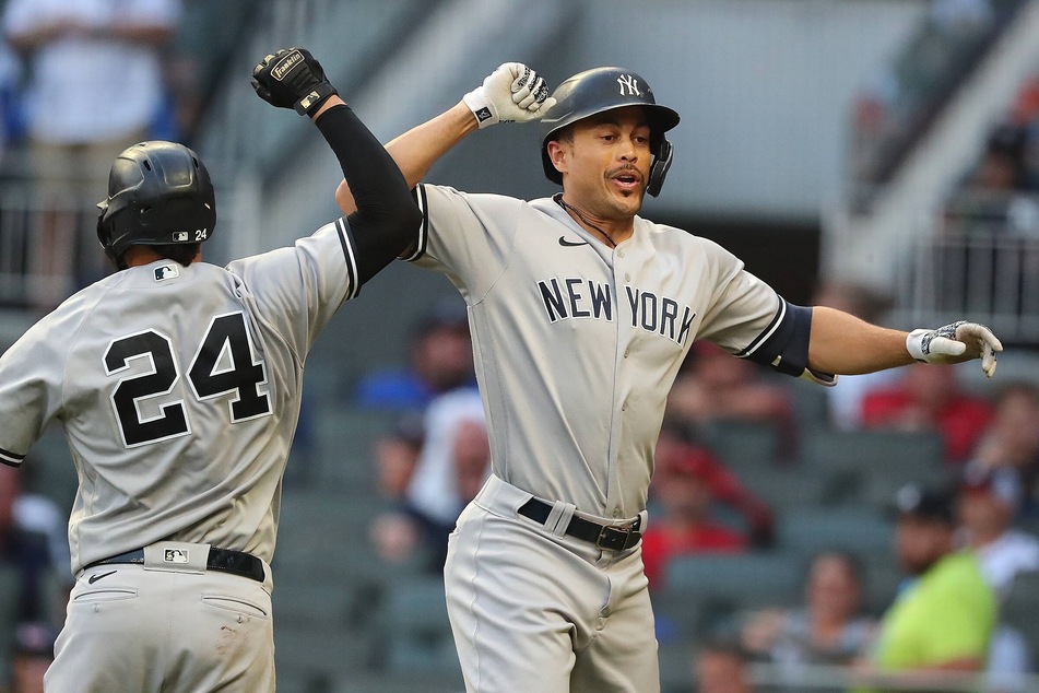 Giancarlo Stanton (r), Gary Sanchez (l), and the Yankees now sit atop the AL Wild Card race after sweeping the Red Sox on Sunday.