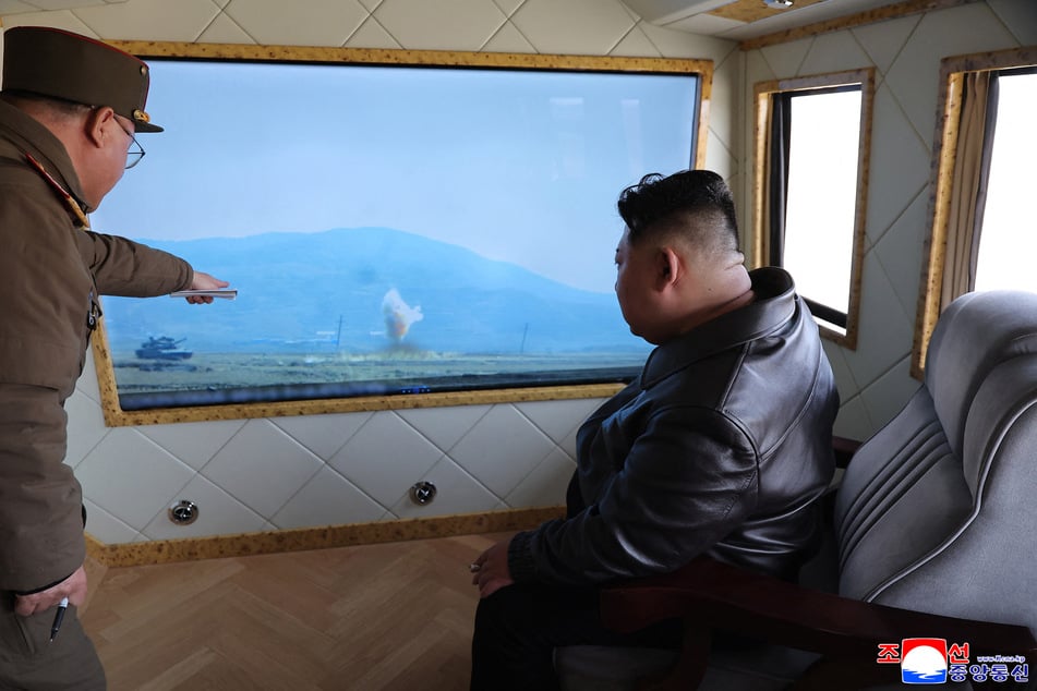 This undated picture released by North Korea's official Korean Central News Agency (KCNA) on Sunday shows North Korean leader Kim Jong Un inspecting a test to verify the active protection system of a new main battle tank at an undisclosed location in North Korea.