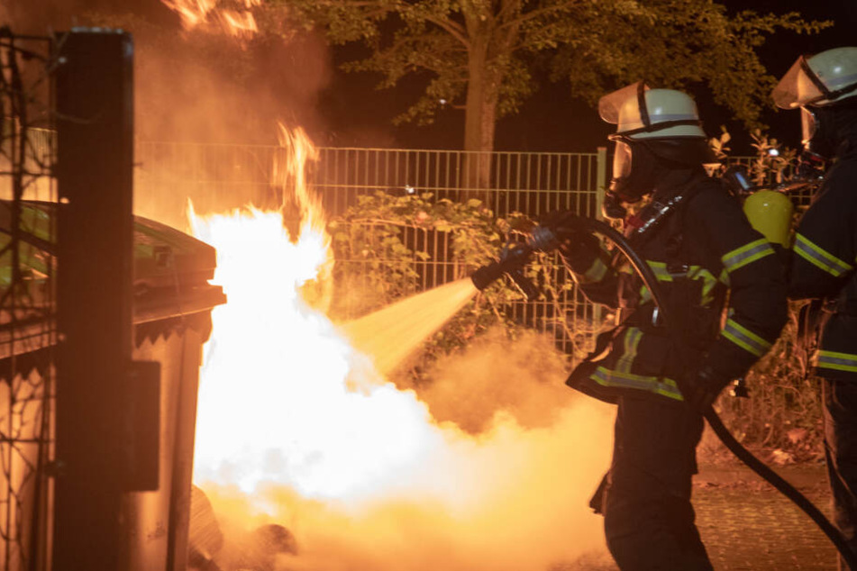 Obwohl die Müllcontainer stark brennen, bekommen die Einsatzkräfte das Feuer schnell in den Griff.