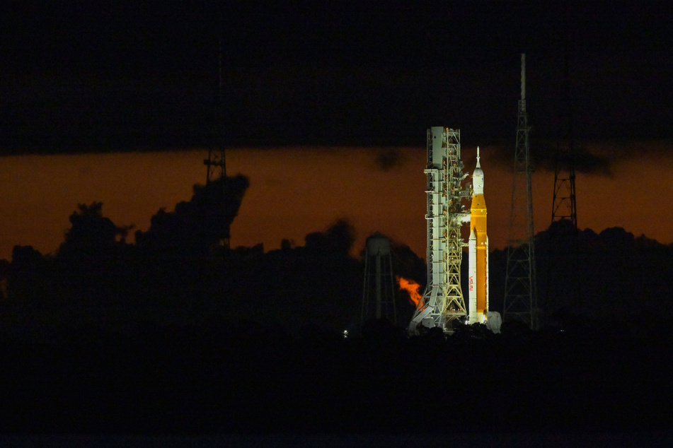 NASA's next-generation moon rocket, the Space Launch System, with its Orion crew capsule on top, sits on the pad early in the morning before the unmanned Artemis 1 mission was scrubbed.