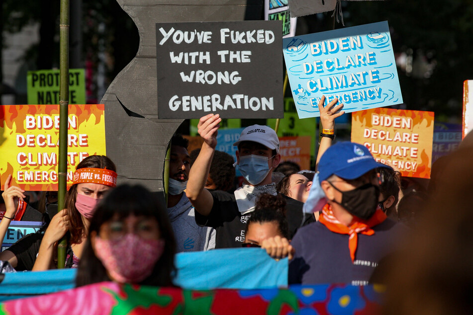 Environmental activists march to the US Capitol on October 15 to demand bold climate action.