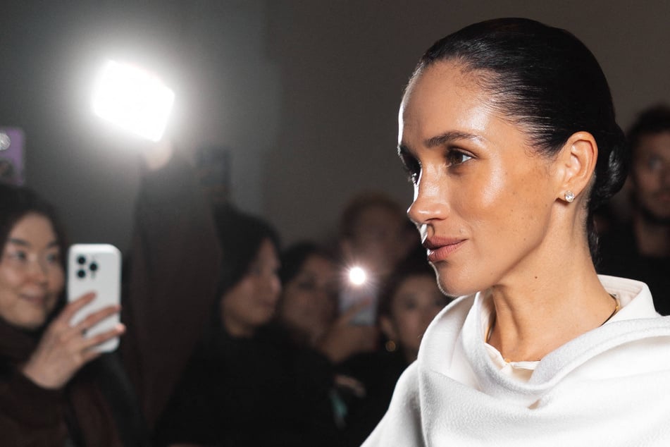 Meghan Markle has set the record straight about her surprise front-row appearance at the Balenciaga show during last month's Paris Fashion Week.