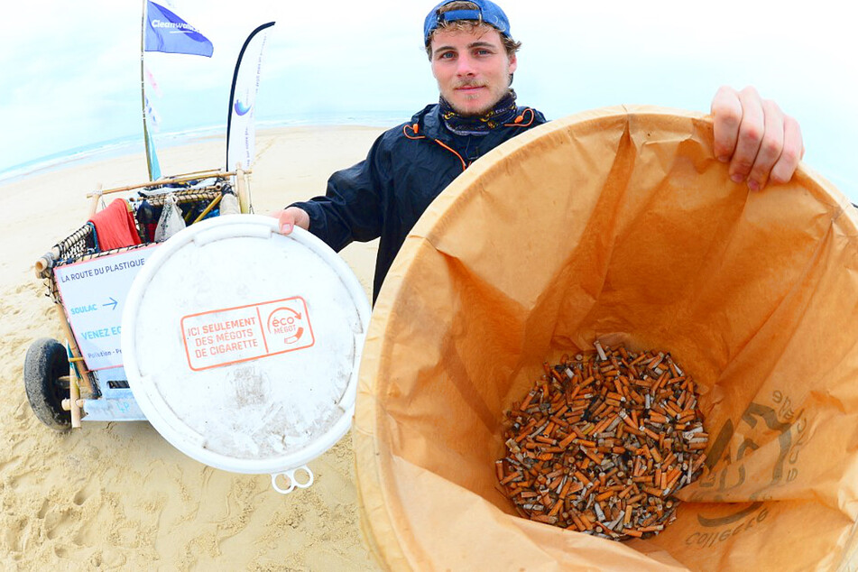 Scientist Aurelien Strmsek shows off his deadly catch, a bucket full of cigarette butts.