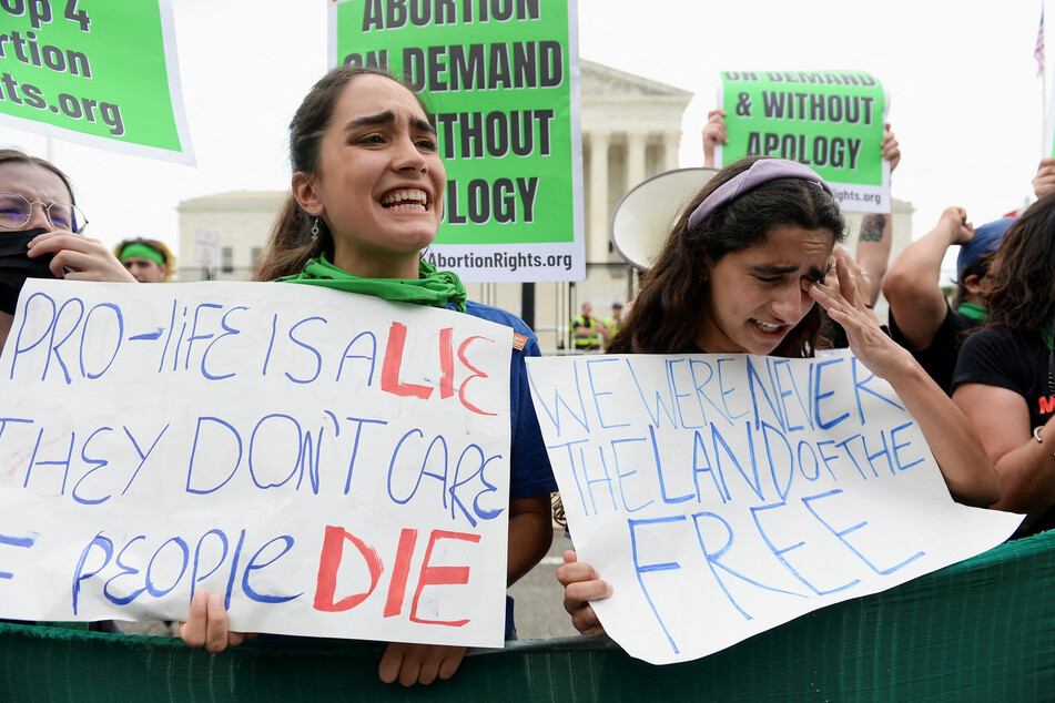 Abortion rights supporters reacted to the overturning of Roe v Wade outside the Supreme Court in Washington on Friday.