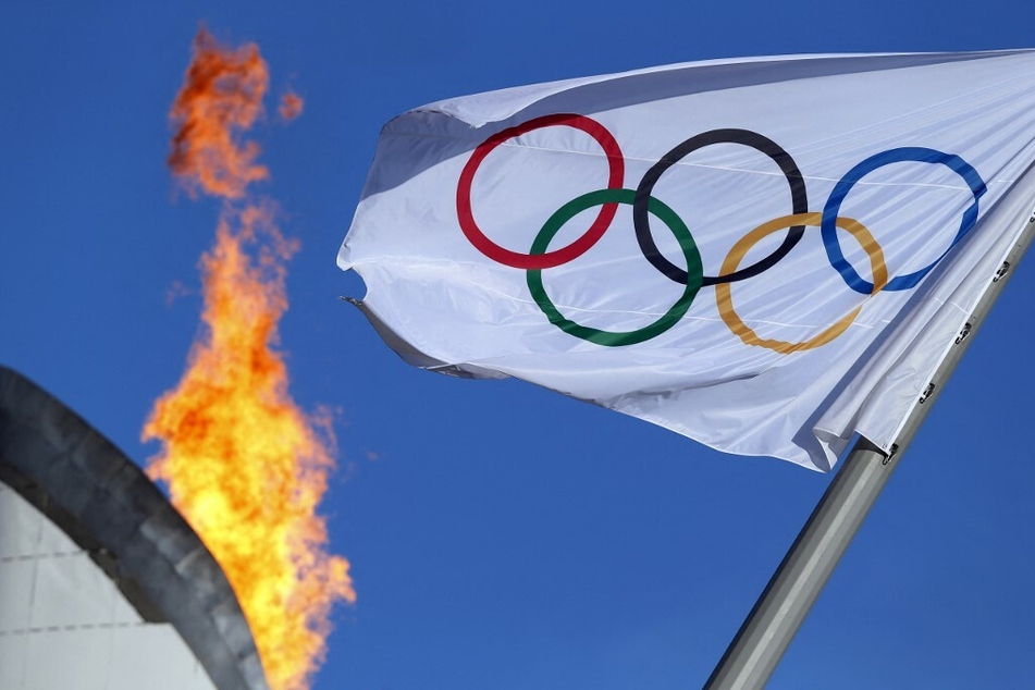 The Olympic flag waves near the Cauldron.