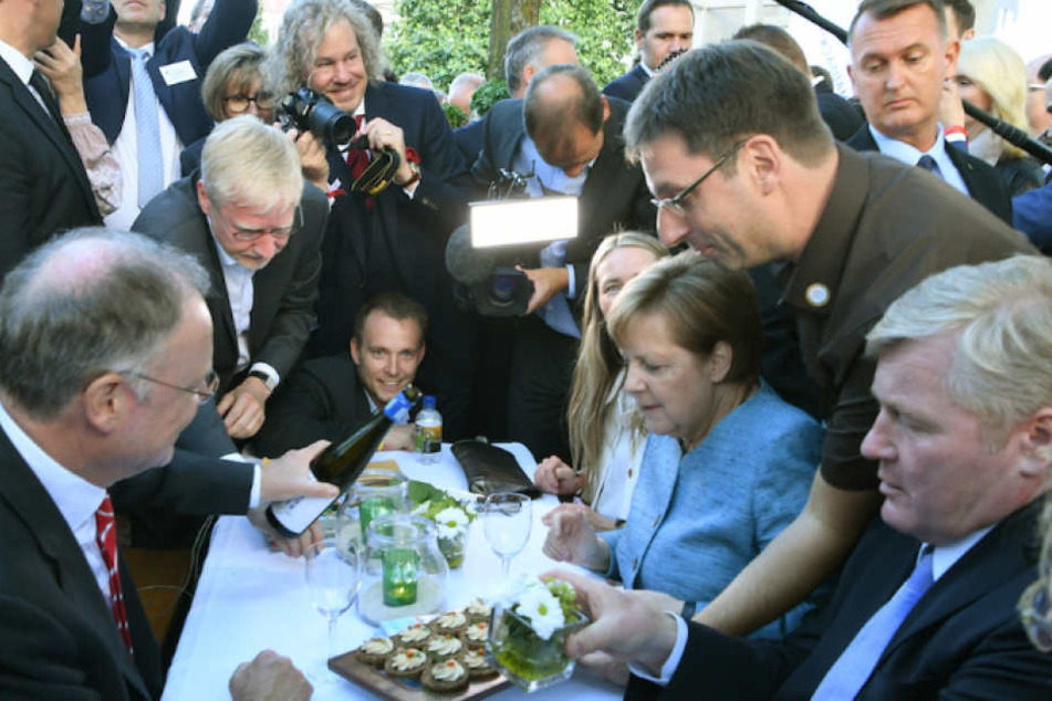 Kanzlerin Merkel wird mit Wein, Sanddorn-Frischkäsecreme und Krabben von der Nordess-Insel Borkum verköstigt.