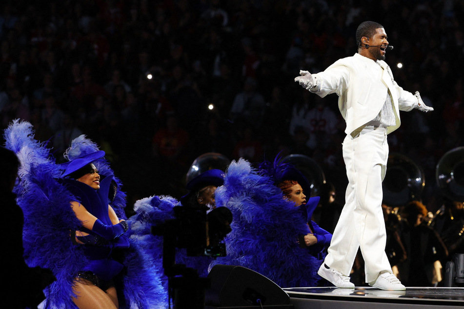Usher performs hits at Super Bowl half-time show beside surprise guests