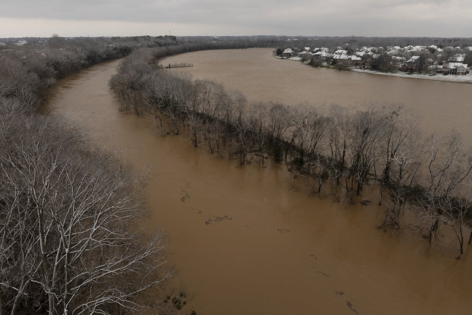 In this aerial view, the Barren River floods after a rain storm on February 16, 2025 in Bowling Green, Kentucky. Severe winter storms brought torrential rains causing intense flooding in Kentucky and parts of Florida and Georgia.