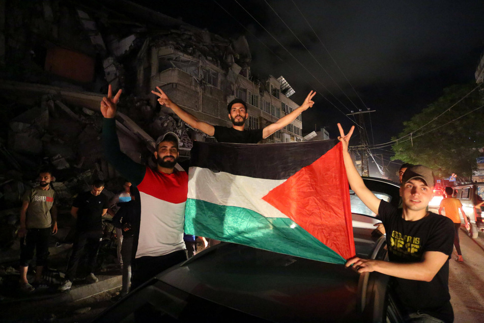 Palestinians celebrate the ceasefire brokered by Egypt.