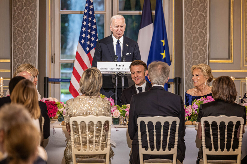 France's President Emmanuel Macron, his wife Brigitte Macron, with US First Lady Jill Biden, listen to US President Joe Biden deliver a speech during a gala dinner at the Elysee Palace in Paris.