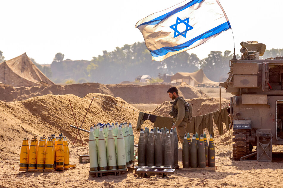 An Israeli soldier arranges artillery shells at a position near the border with the Gaza Strip in southern Israel on November 6, 2023.