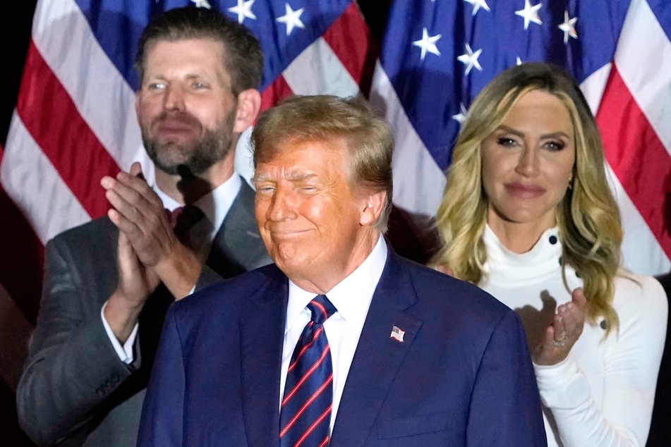 Presidential candidate Donald Trump (c.) flanked by his son, Eric Trump (l.) and wife Lara during an Election Night Party in Nashua, New Hampshire, on January 23, 2024.