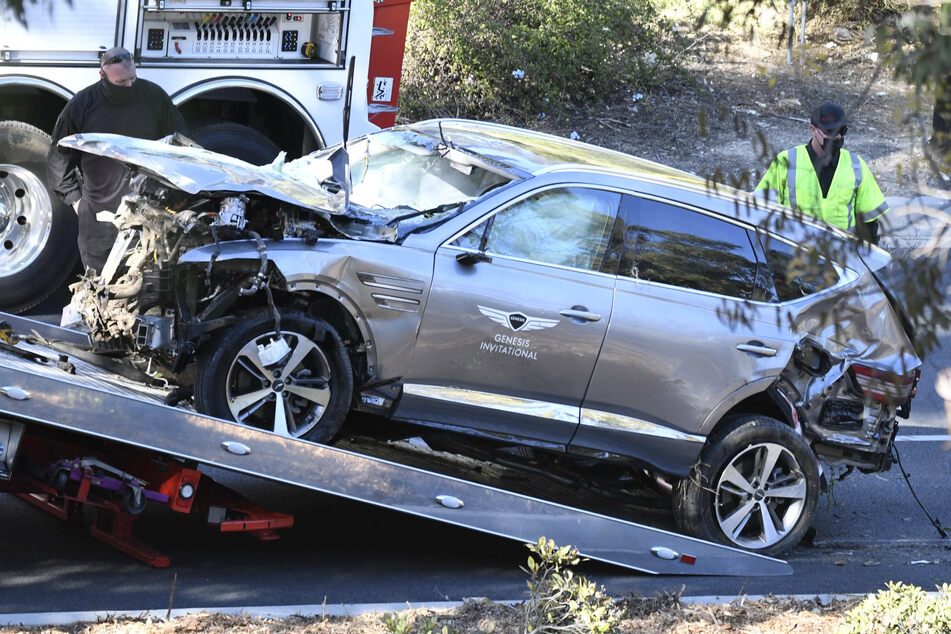Tiger Woods car being towed after his horrific accident in February.