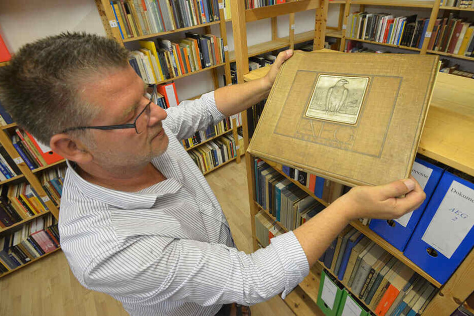 Ingo Pötschke (53) hält eine Festschrift der Firma SIEMENS aus dem Jahr 1908 in den Händen.
