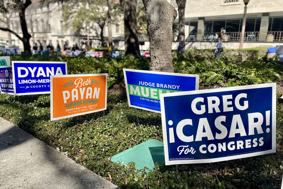Political campaign signs line the outside of a polling location in Austin, Texas.
