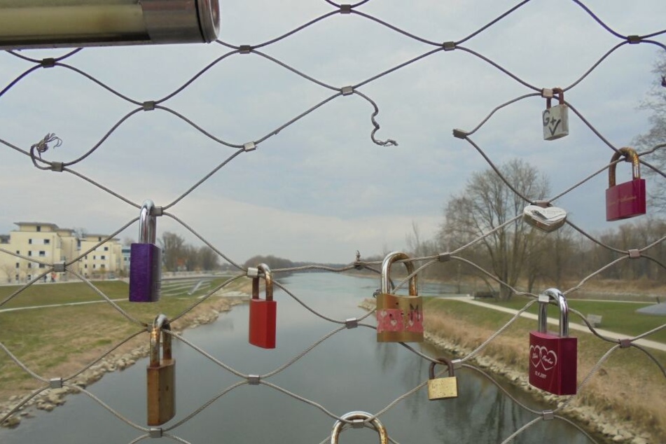Liebesschlösser hängen an einer Brücken im Mangfallpark.