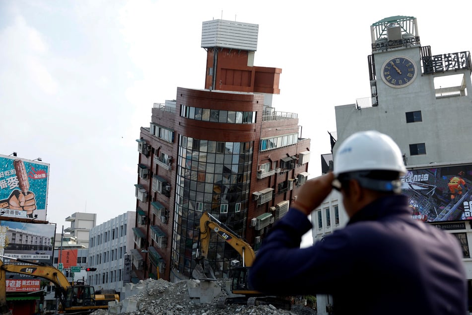 Workers carry out operations at the site where a building collapsed, following the earthquake, in Hualien, Taiwan.