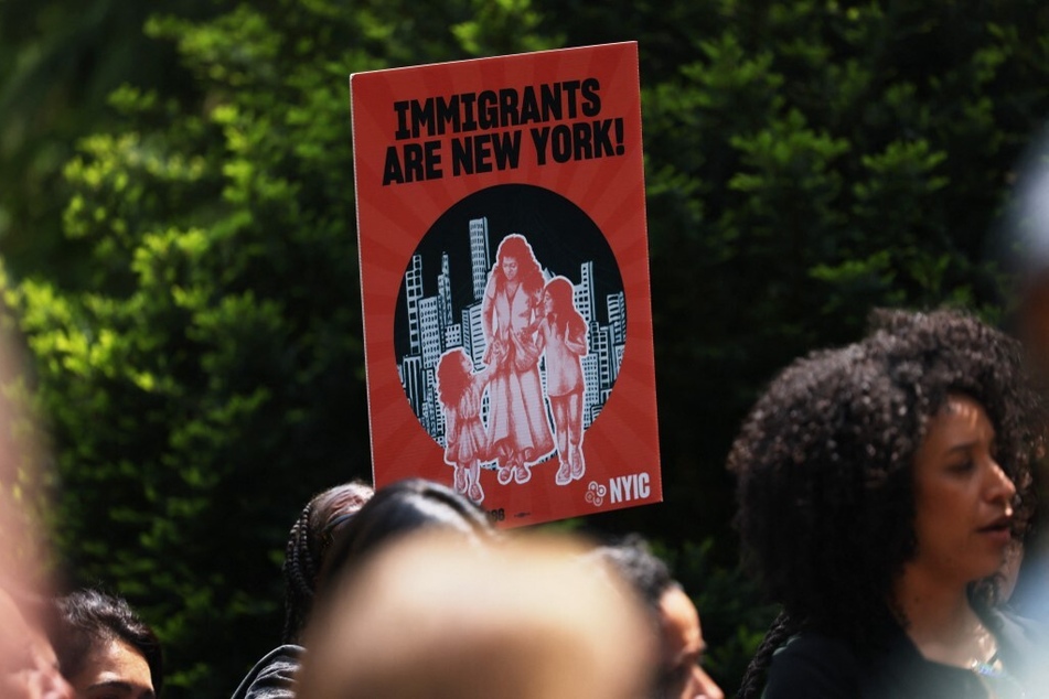 Demonstrators rally for immigrants' rights outside New York City Hall.