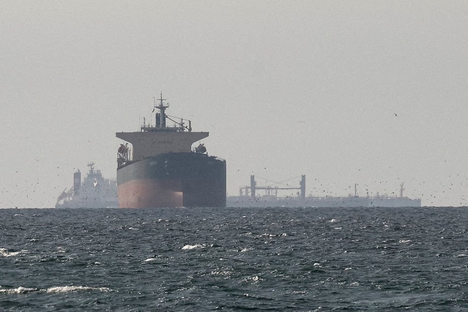 Cargo ships in the Gulf, near the Strait of Hormuz, are seen from northern Ras al-Khaimah in the United Arab Emirates amid the US-Israeli war on Iran on March 11, 2026.