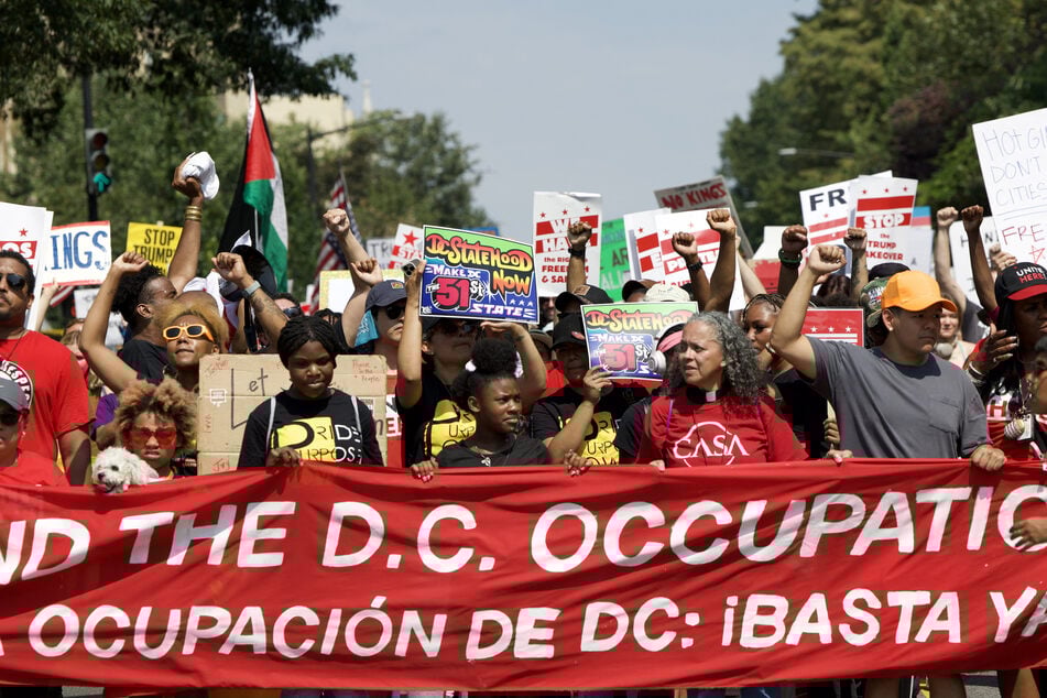 Demonstrators take part in the "We Are All DC" national march calling for an end to the deployment of National Guard troops in Washington DC on September 6, 2025.