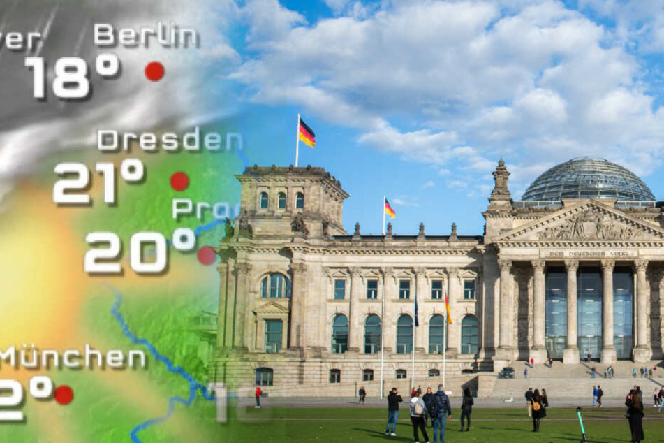 Menschen stehen auf der Wiese vor dem Reichstagsgebäude.