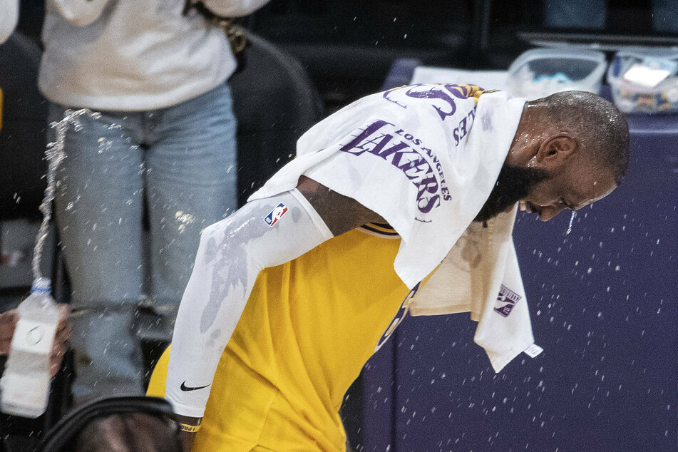 LeBron James gets soaked by Kent Bazemore after the Lakers' big win.
