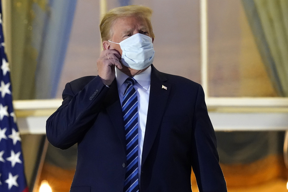 President Donald Trump taking off his mask after returning to the White House, following his hospitalization for Covid-19.