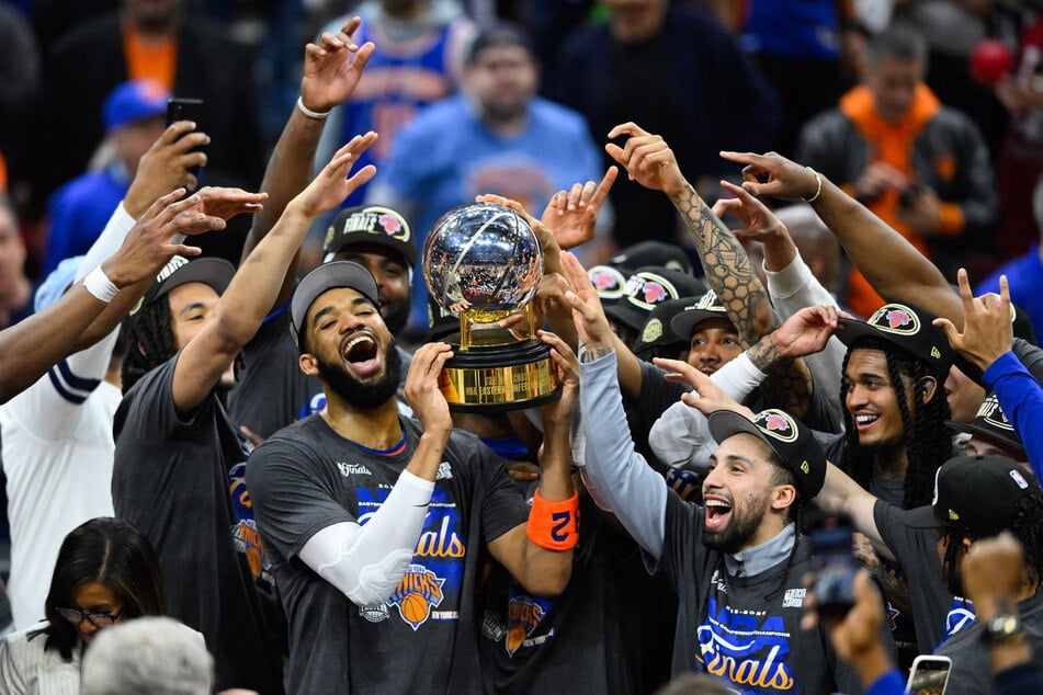 New York Knicks center Karl-Anthony Towns lifts the 2026 Eastern Conference trophy with his teammates after defeating the Cleveland Cavaliers in game four of the eastern conference finals for the 2026 NBA playoffs at Rocket Arena.