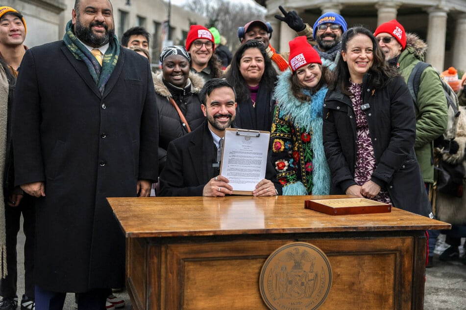 New York City Mayor Zohran Mamdani (c.) holds a signed executive order during a press conference at Grand Army Plaza in Brooklyn, New York City, on January 2, 2026.