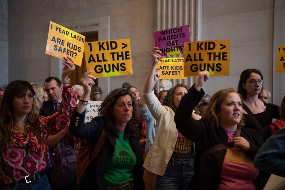 Protesters call for stricter gun laws after being removed from the gallery at the Tennessee Capitol during a Senate hearing on a bill that would allow public school teachers to carry concealed firearms.