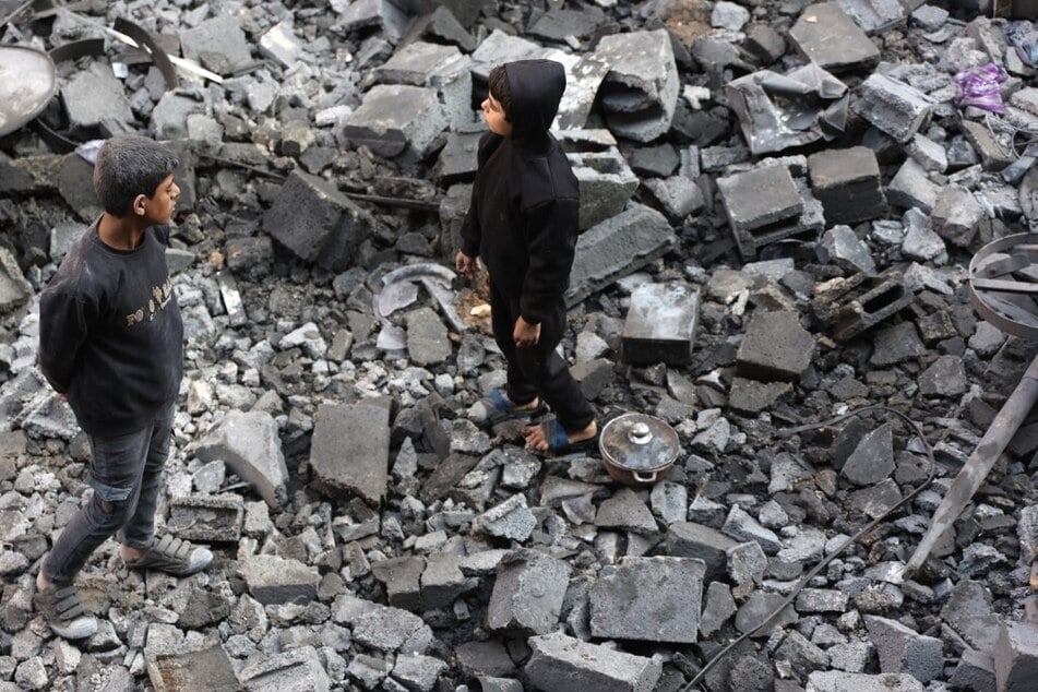 Palestinian children stand in the rubble after an Israeli strike in Jabalia in the central Gaza Strip.