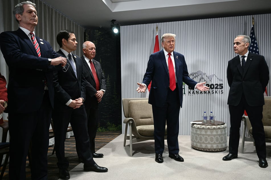 US President Donald Trump (second from r.) speaks as Canadian Prime Minister Mark Carney (r.) listens, joined by US Secretary of Treasury Scott Bessent, US Secretary of State Marco Rubio, and US Ambassador to Canada Pete Hoekstra, during the G7 Summit on June 16, 2025.