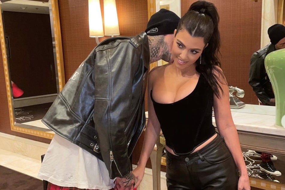 Kourtney Kardashian (r) and Travis Barker gave fans something to talk about during their weekend vacay at UFC 264 in July 2021.