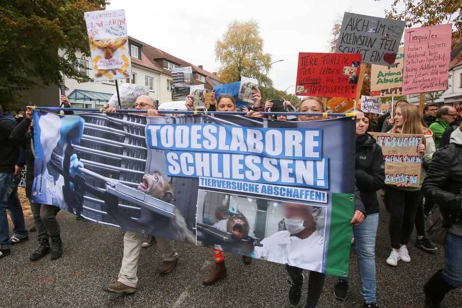 Mit Schildern und Transparenten auf denen auch der Schriftzug "Todeslabore schliessen" zu sehen ist, demonstrieren Teilnehmer in Hamburg-Neugraben gegen Tierversuche. (Archivbild)