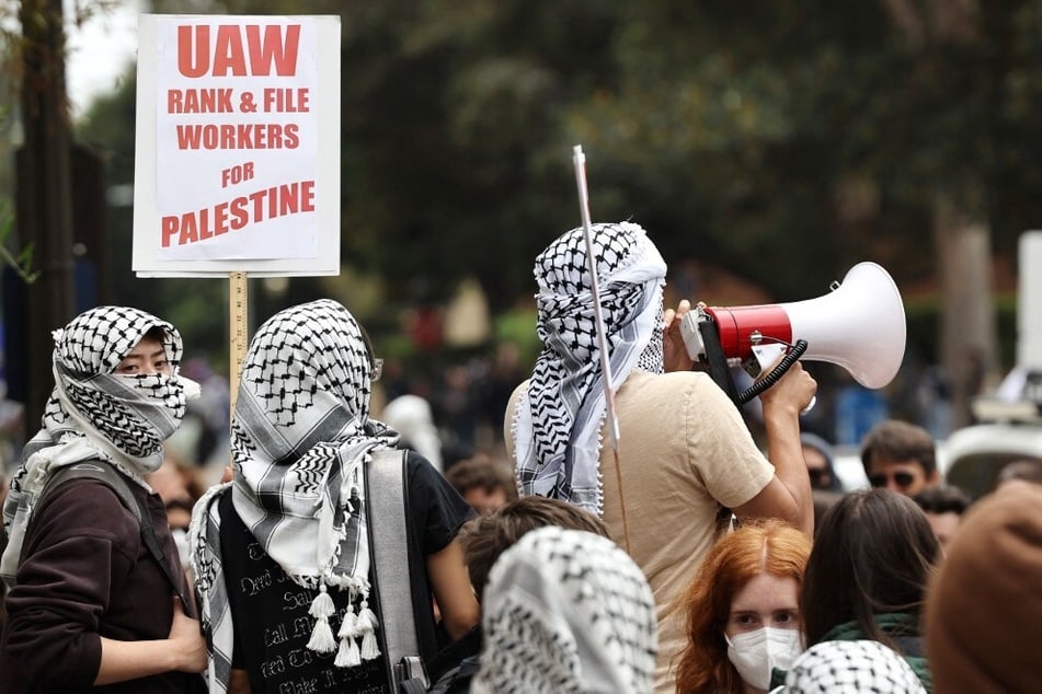 Gaza solidarity protestors rally with a sign reading "UAW Rank &amp; File Workers For Palestine" after police cleared an encampment on the University of California, Los Angeles campus in May 2024.