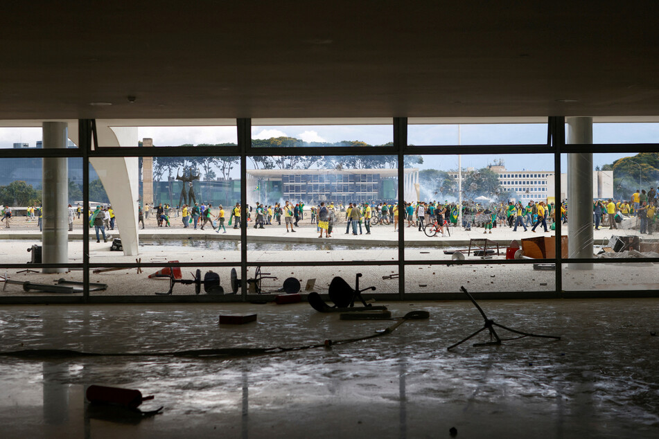 During the violence in Brasília, Bolsonaro supporters ransacked the National Congress building, climbing on the roof and smashing windows.