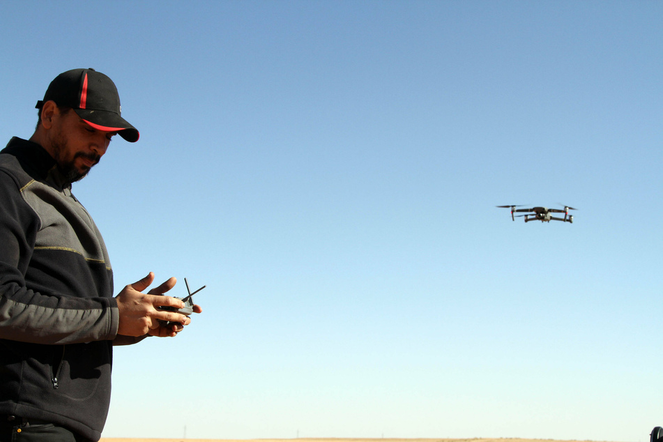 A man prepares a drone to take photos of the desert during a large desert tourism event in Shwayrif, a village southwest of Libya's capital Tripoli.