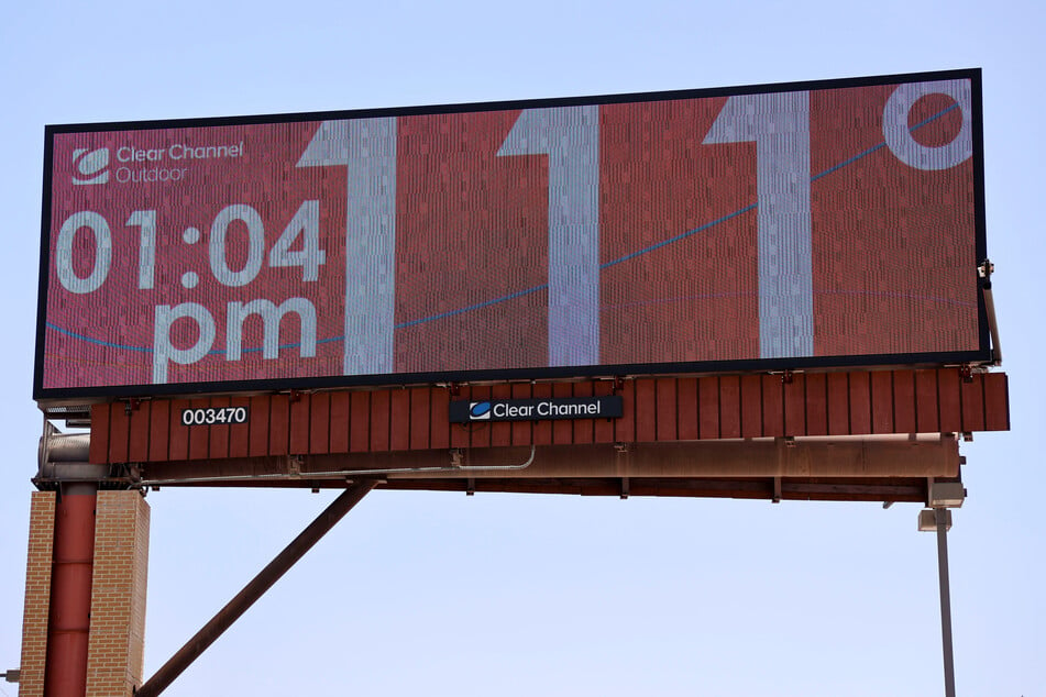 Billboards in Phoenix, Arizona, display record-breaking temperatures amid a dangerous heat wave across the US southwest.